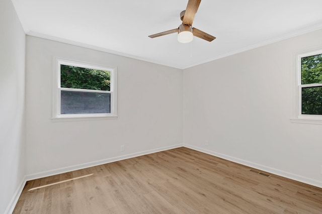 empty room featuring light wood-style flooring, baseboards, ceiling fan, and ornamental molding