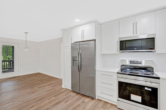 kitchen with stainless steel appliances, light wood-style floors, white cabinetry, light countertops, and crown molding