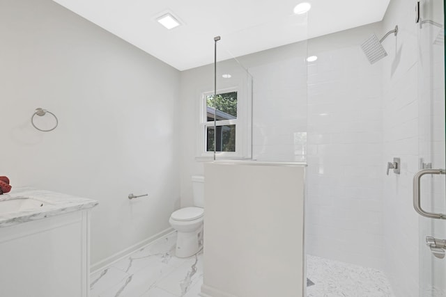 bathroom featuring a tile shower, toilet, marble finish flooring, vanity, and baseboards