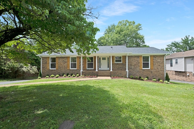 ranch-style house with a front yard and brick siding