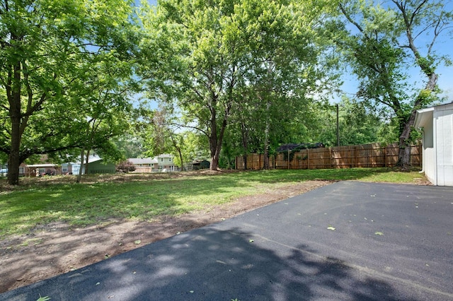 view of yard featuring fence and a patio area