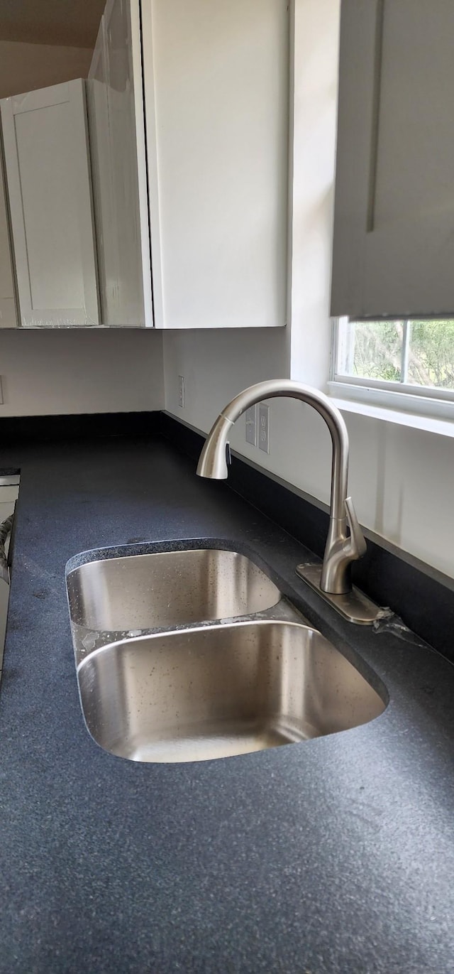 830 Finley Beech Rd, Lewisburg, TN 37091 - kitchen view of a sink, white cabinets, and dark countertops