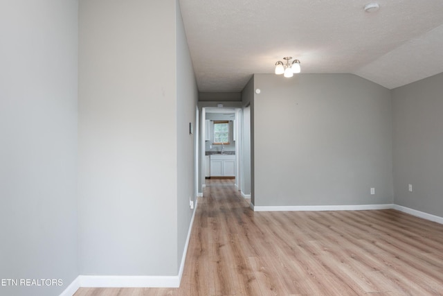 112 Pelham Rd, Knoxville, TN 37914 - additional living space featuring light wood-style flooring, baseboards, and vaulted ceiling