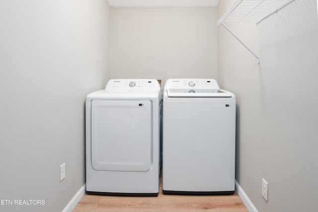 112 Pelham Rd, Knoxville, TN 37914 - washroom featuring washing machine and clothes dryer, light wood-style floors, and baseboards