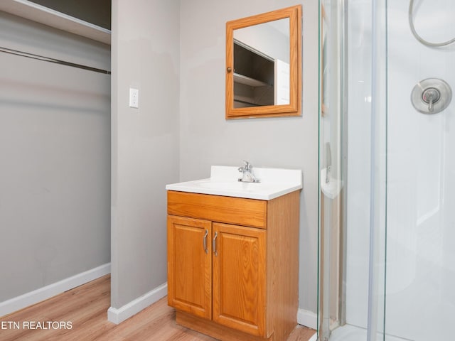 112 Pelham Rd, Knoxville, TN 37914 - bathroom with wood finished floors, a stall shower, vanity, and baseboards