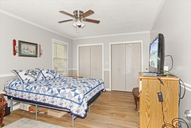 128 Ramsey Rd, Manchester, TN 37355 - bedroom with light wood finished floors, multiple closets, a textured ceiling, crown molding, and a ceiling fan