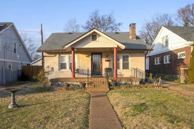 bungalow-style home with a porch, a shingled roof, and a chimney
