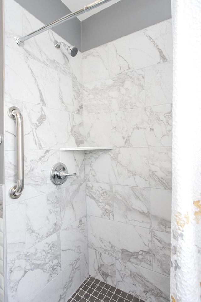 bathroom with tiled shower