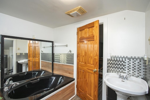 bathroom featuring backsplash and a sink