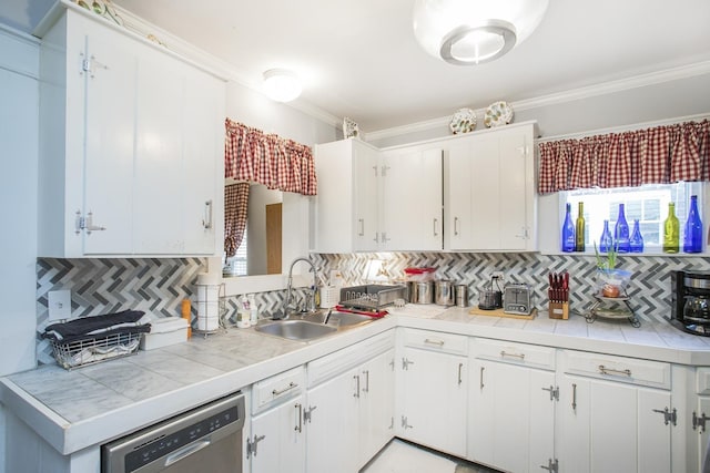 kitchen with dishwasher, a sink, tasteful backsplash, crown molding, and white cabinets
