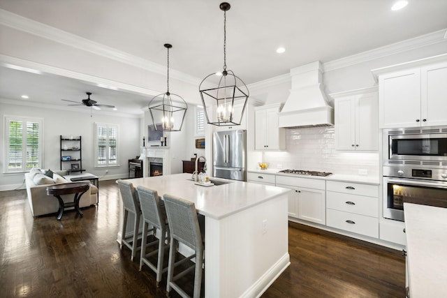 4091 Camberley St, Franklin, TN 37064 - kitchen featuring appliances with stainless steel finishes, custom exhaust hood, a sink, light countertops, and recessed lighting