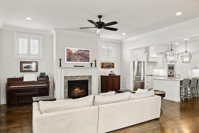 4091 Camberley St, Franklin, TN 37064 - living room featuring ceiling fan, dark wood finished floors, crown molding, a lit fireplace, and recessed lighting