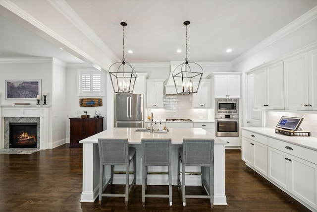 4091 Camberley St, Franklin, TN 37064 - kitchen featuring stainless steel appliances, a chandelier, backsplash, a breakfast bar, and light countertops