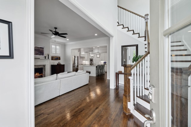 4091 Camberley St, Franklin, TN 37064 - living area with stairs, ornamental molding, dark wood-style floors, a fireplace, and ceiling fan