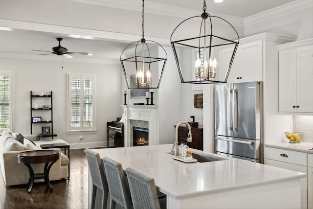 4091 Camberley St, Franklin, TN 37064 - kitchen with freestanding refrigerator, open floor plan, healthy amount of natural light, an island with sink, and ornamental molding