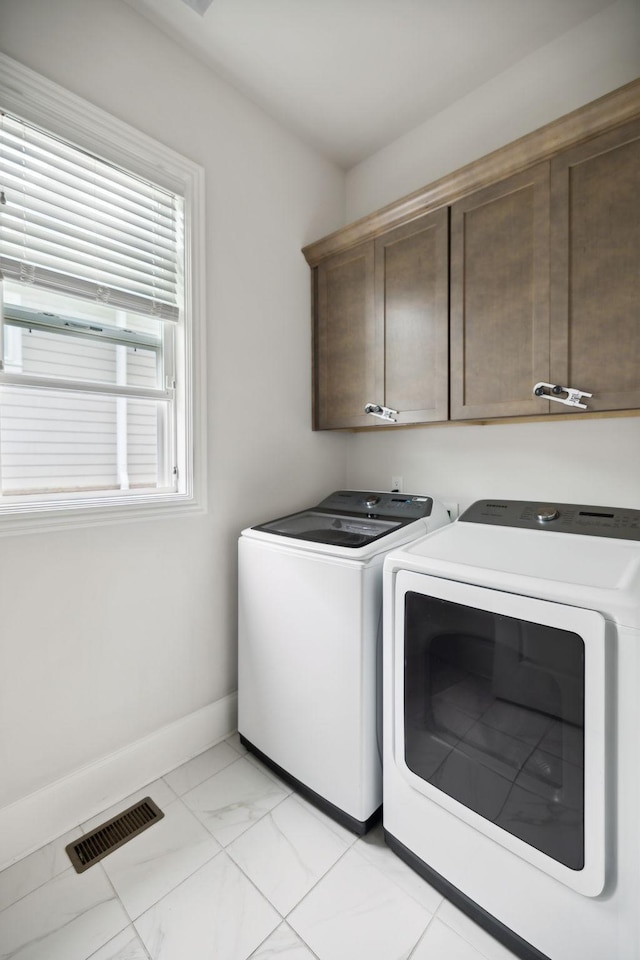 4091 Camberley St, Franklin, TN 37064 - laundry room featuring separate washer and dryer, cabinet space, baseboards, and light marble finish flooring