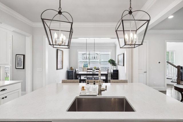 4091 Camberley St, Franklin, TN 37064 - kitchen featuring a chandelier, pendant lighting, a center island with sink, a sink, and ornamental molding