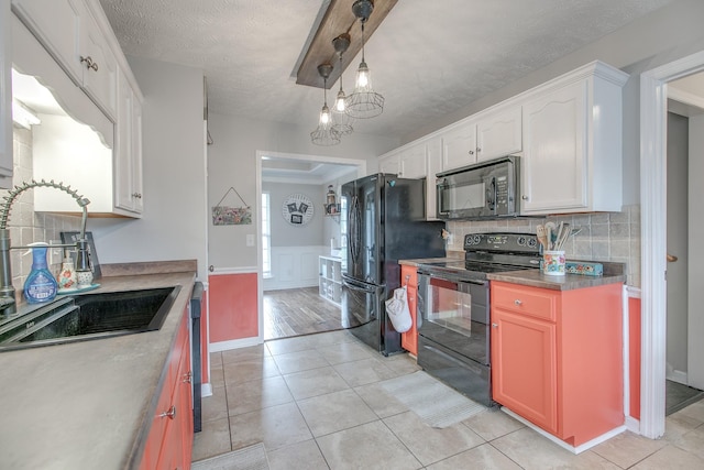 5064 Tricia Pl, Murfreesboro, TN 37129 - kitchen featuring black appliances, a sink, white cabinetry, light tile patterned floors, and a textured ceiling