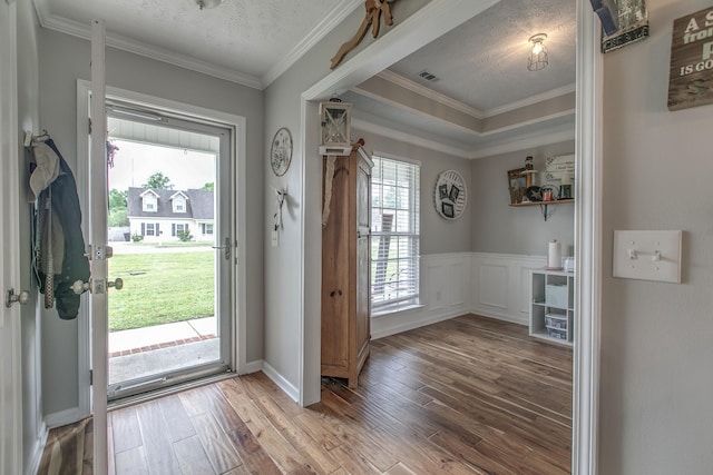 5064 Tricia Pl, Murfreesboro, TN 37129 - doorway to outside featuring wood finished floors, crown molding, and a textured ceiling