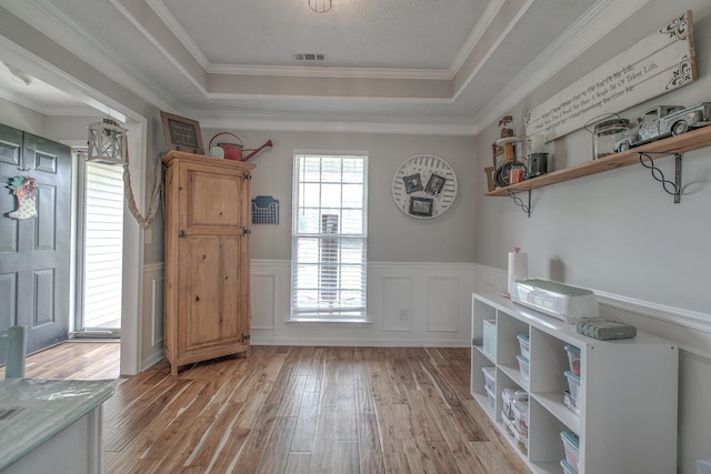 5064 Tricia Pl, Murfreesboro, TN 37129 - doorway to outside with a tray ceiling, light wood finished floors, wainscoting, crown molding, and a decorative wall