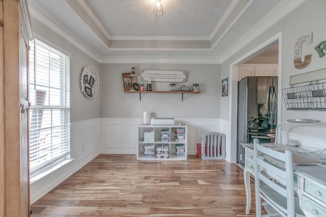 5064 Tricia Pl, Murfreesboro, TN 37129 - dining room featuring a tray ceiling, light wood-style floors, wainscoting, a decorative wall, and crown molding