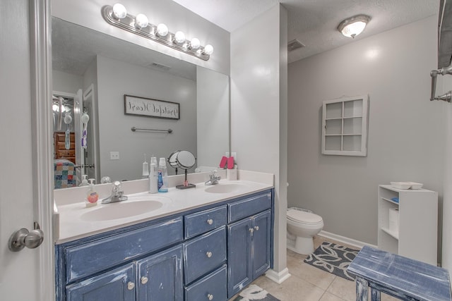 5064 Tricia Pl, Murfreesboro, TN 37129 - bathroom with ensuite bathroom, double vanity, toilet, tile patterned flooring, and a textured ceiling