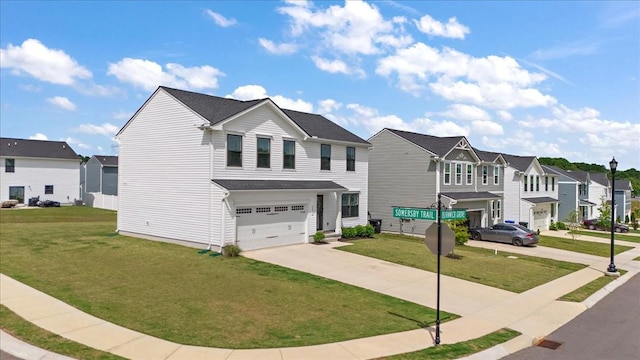 view of front of home with a residential view, driveway, an attached garage, and a front lawn