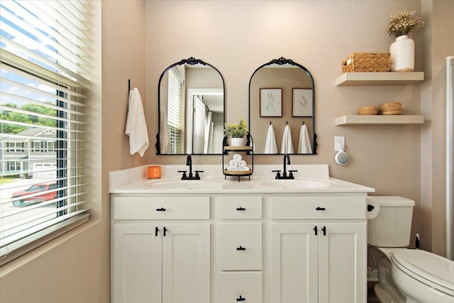 full bath with toilet and double vanity
