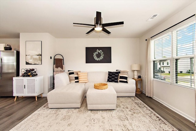 living area with wood finished floors, ceiling fan, and baseboards