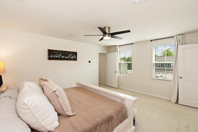 bedroom featuring light carpet, baseboards, and ceiling fan