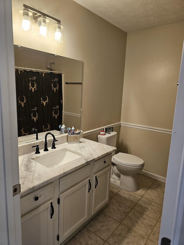 full bathroom with toilet, tile patterned flooring, a textured ceiling, vanity, and a shower with curtain