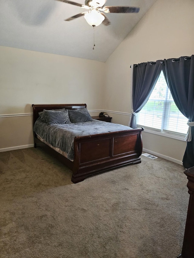 carpeted bedroom featuring vaulted ceiling, baseboards, and a ceiling fan