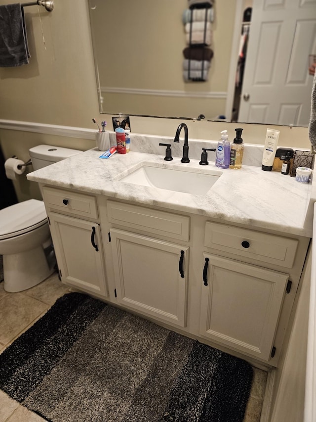 bathroom featuring vanity, toilet, and tile patterned flooring