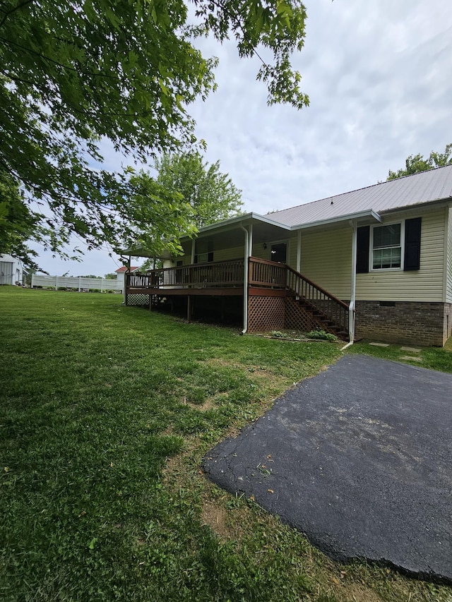 view of grassy yard featuring a wooden deck