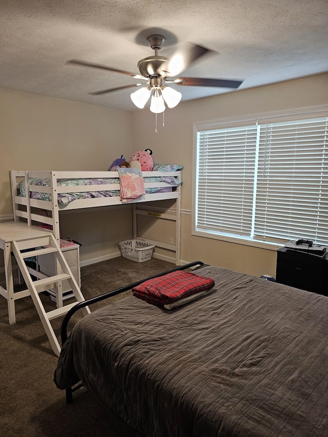 carpeted bedroom with a textured ceiling and a ceiling fan