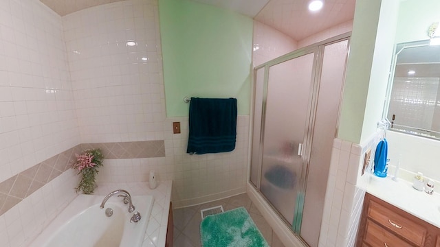 168 Maple Valley Ln, Cookeville, TN 38506 - bathroom with tile walls, a stall shower, a bath, vanity, and tile patterned flooring