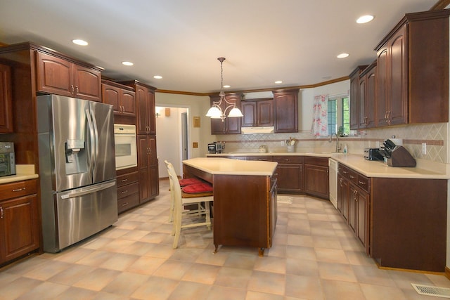 168 Maple Valley Ln, Cookeville, TN 38506 - kitchen with white appliances, crown molding, a center island, light flooring, and a sink
