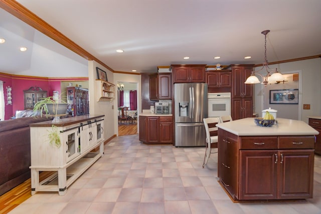 168 Maple Valley Ln, Cookeville, TN 38506 - kitchen featuring stainless steel fridge, white oven, crown molding, light countertops, and pendant lighting