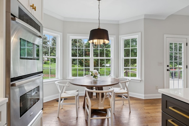 336 Alfred Ladd Rd E, Franklin, TN 37064 - dining room with healthy amount of natural light, ornamental molding, wood finished floors, baseboards, and a chandelier