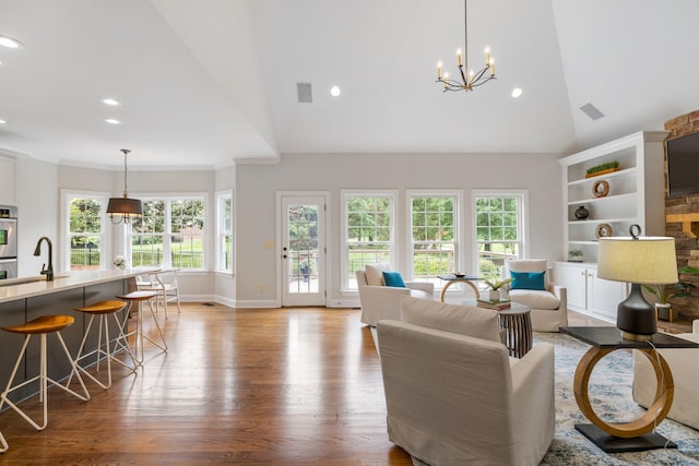 336 Alfred Ladd Rd E, Franklin, TN 37064 - living area with wood finished floors, healthy amount of natural light, recessed lighting, a chandelier, and baseboards
