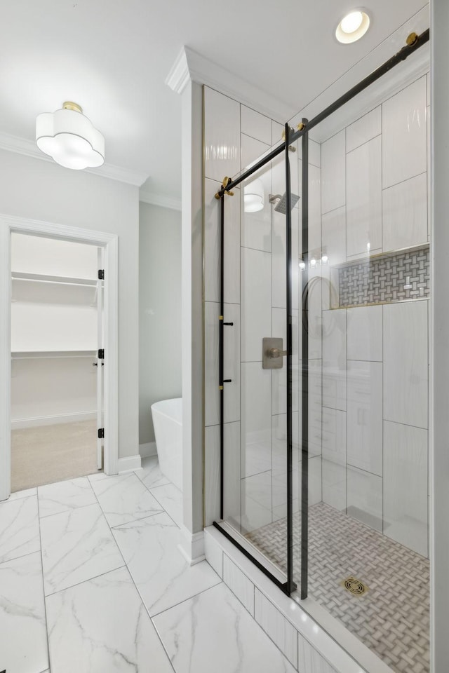 336 Alfred Ladd Rd E, Franklin, TN 37064 - full bath featuring crown molding, a soaking tub, a stall shower, marble finish floors, and baseboards