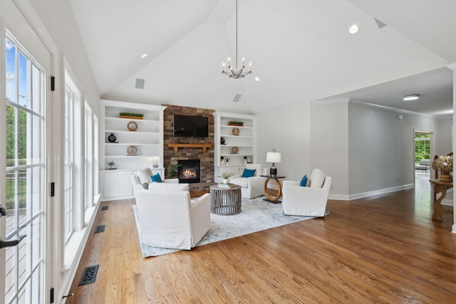 336 Alfred Ladd Rd E, Franklin, TN 37064 - living room with wood finished floors, a fireplace, built in shelves, a chandelier, and baseboards