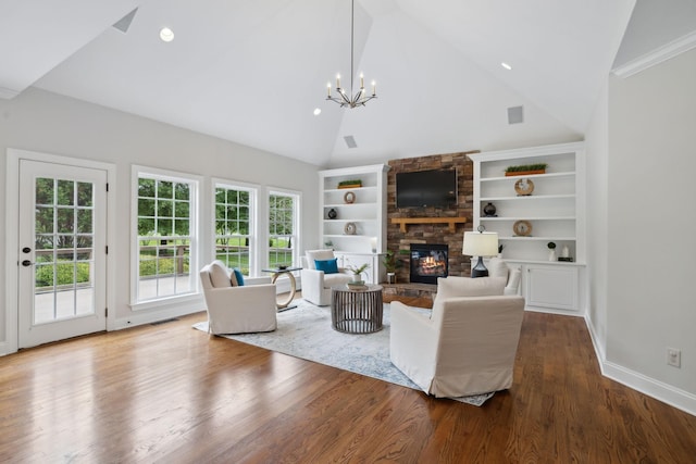 336 Alfred Ladd Rd E, Franklin, TN 37064 - living area featuring a stone fireplace, a chandelier, wood finished floors, built in features, and baseboards