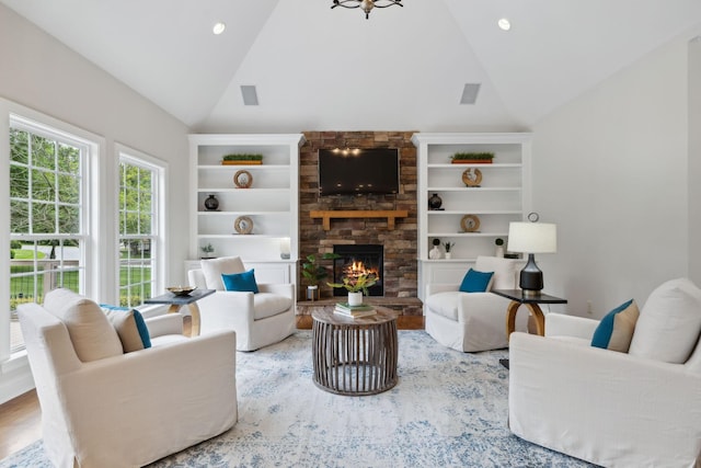 336 Alfred Ladd Rd E, Franklin, TN 37064 - living area with vaulted ceiling, a stone fireplace, wood finished floors, and recessed lighting
