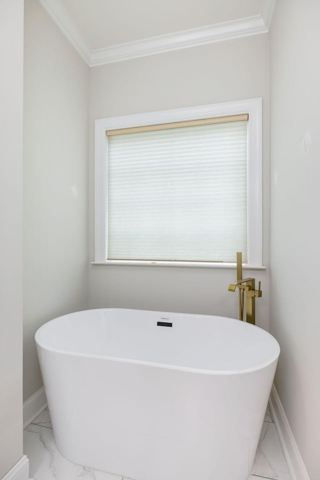 336 Alfred Ladd Rd E, Franklin, TN 37064 - bathroom with marble look tile flooring, crown molding, a freestanding tub, and baseboards