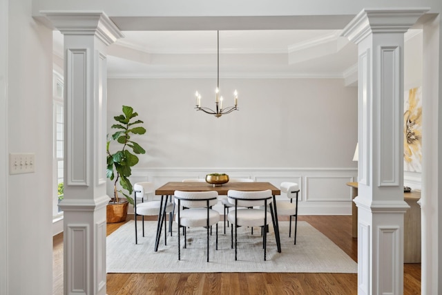 336 Alfred Ladd Rd E, Franklin, TN 37064 - dining area featuring ornate columns, wood finished floors, crown molding, a wainscoted wall, and a raised ceiling