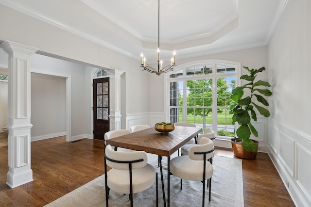 336 Alfred Ladd Rd E, Franklin, TN 37064 - dining area featuring ornate columns, dark wood-style floors, a raised ceiling, crown molding, and wainscoting