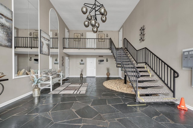 536 River St Unit 536, Chattanooga, TN 37405 - foyer entrance with stone floors, a high ceiling, stairway, baseboards, and a chandelier