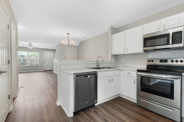 608 Flintlock Ct, Nashville, TN 37217 - kitchen featuring appliances with stainless steel finishes, a sink, dark wood finished floors, and white cabinetry