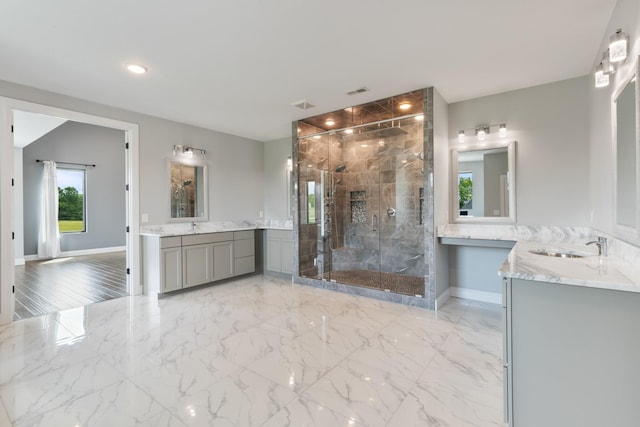 full bathroom with a shower stall, baseboards, two vanities, recessed lighting, and a large fireplace